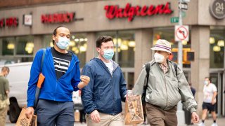 People wear protective face masks outside Walgreens pharmacy in Union Square as the city continues Phase 4 of re-opening following restrictions imposed to slow the spread of coronavirus on September 24, 2020 in New York City.