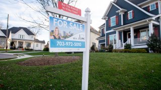 A house’s real estate for sale sign is seen in front of a home in Arlington, Virginia, November 19, 2020.