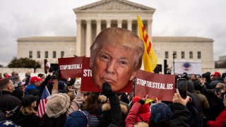 People listen to speakers during a Stop the Steal rally in front of the Supreme Court on Tuesday, Jan. 5, 2021 in Washington, DC.