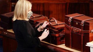 Electoral College ballot boxes arrive as a joint session of the House and Senate convenes to confirm the Electoral College votes cast in November’s election, at the Capitol in Washington, Wednesday, Jan. 6, 2021.
