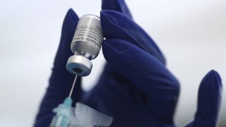 A healthcare worker prepares a Pfizer coronavirus disease (COVID-19) vaccination in Los Angeles, California, January 7, 2021.