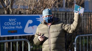 A school bus driver gestures after receiving a dose of the Moderna coronavirus disease (COVID-19) vaccine at a vaccination site at South Bronx Educational Campus, in the Bronx New York on January 10, 2021.