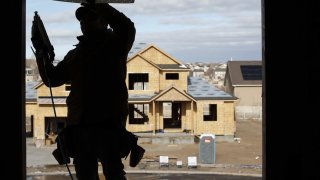 A contractor frames a house under construction in Lehi, Utah, U.S., on Wednesday, Dec. 16, 2020. Private residential construction in the U.S. rose 2.7% in November.