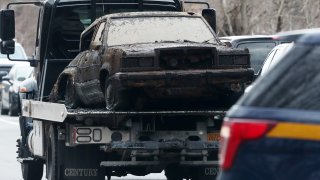 Car on tow truck after pulled from reservoir