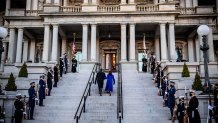Vice President Kamala Harris (C) and US Second Gentleman Doug Emhoff walk up the stairs of the Eisenhower Building