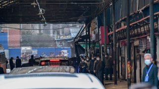 Cars transporting members of the World Health Organization (WHO) team, investigating the origins of the Covid-19 coronavirus, arrive at the closed Huanan Seafood wholesale market in Wuhan, China's central Hubei province on January 31, 2021.