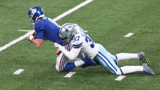 Daniel Jones #8 of the New York Giants is sacked by Donovan Wilson #37 of the Dallas Cowboys