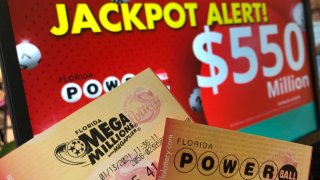 Powerball and Mega Millions lottery tickets are shown at a retailer, Wednesday, Jan. 13, 2021, in Surfside, Fla. Lottery players will have a shot Friday night at the fifth-largest jackpot in U.S. history after no tickets matched all the numbers in the latest Mega Millions drawing. The big prize for Powerball, the other national lottery game, is $550 million for Wednesday night’s drawing.