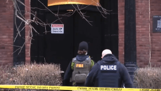 Federal officials search the resident of Edward Lang following his arrest for alleged involvement for the riot at the U.S. Capitol on Jan. 6