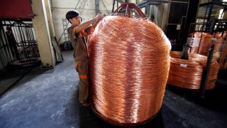 A worker labels copper products at Truong Phu cable factory in northern Hai Duong province, outside Hanoi, Vietnam August 11, 2017.
