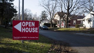 An “Open House” sign is displayed in the front yard of a home for sale in Columbus, Ohio.