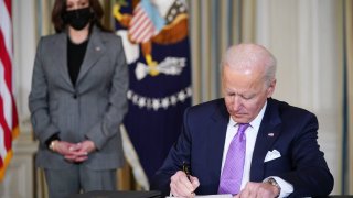 Vice President Kamala Harris watches as President Joe Biden signs executive orders after speaking on racial equity in the State Dining Room of the White House in Washington, DC on January 26, 2021.