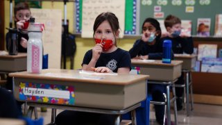 Schoolchildren swab and test themselves for COVID-19 to prevent the spread of the coronavirus disease (COVID-19) in the classroom at South Boston Catholic Academy in Boston, Massachusetts, January 28, 2021.