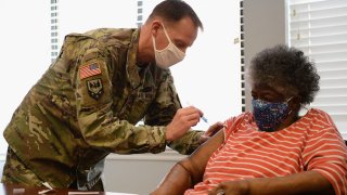 In this Feb. 11, 2021, file photo, Staff Sergeant Herbert Lins of the Missouri Army National Guard administers the COVID-19 vaccine to a resident during a vaccination event at the Jeff Vander Lou Senior living facility in St Louis, Missouri.