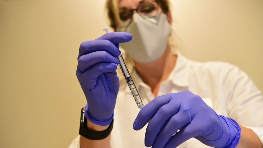 A Johnson & Johnson worker prepares a syringe during the Phase 3 ENSEMBLE trial of its Janssen coronavirus disease (COVID-19) vaccine candidate in an undated photograph.