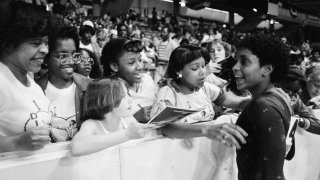 In this June 5, 1983, file photo, Dianne Durham, right, of Gary, Ind., gives autographs after winning the women's title at the McDonald's U.S.A. Gymnastic Championships at the University of Illinois in Chicago. Durham, the first Black woman to win a USA Gymnastics national championship, died on Thursday, Feb. 4, 2021, She was 52.