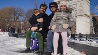 New York State Senator Brad Hoylman, left, with his husband David Sigal, right, pose with their daughters