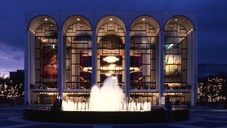 Exterior view of the Metropolitan Opera House at night in New York, New York.