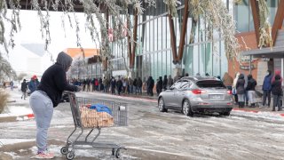 People wait in line outside one of a HEB Grocery Co. grocery store in Austin, Texas, U.S., on Wednesday, Feb. 17, 2021. The crisis that has knocked out power for days to millions of homes and businesses in Texas and across the central U.S. is getting worse, with blackouts expected to last until at least Thursday.