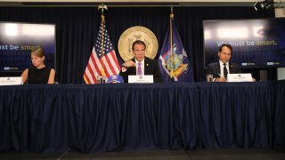 New York state Gov. Andrew Cuomo, flanked by Melissa DeRosa, secretary to the governor; and state Budget Director Robert Mujica, speaks at a news conference on September 08, 2020 in New York City