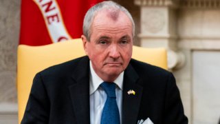 Gov. Phil Murphy on a yellow chair with a frown.
