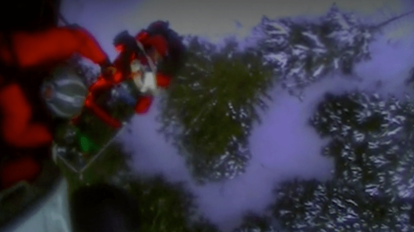 This screenshot from video shows the U.S. Coast Guard rescuing a skier who was attacked by a bear in Alaska's backcountry.