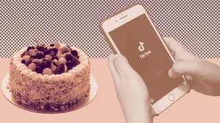 iPhone with TikTok logo next to a cake.