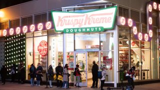 People line up outside Krispy Kreme in Times Square amid the coronavirus pandemic on March 17, 2021 in New York City. After undergoing various shutdown orders for the past 12 months the city is currently in phase 4 of its reopening plan, allowing for the reopening of low-risk outdoor activities, movie and television productions, indoor dining as well as the opening of movie theaters, all with capacity restrictions.