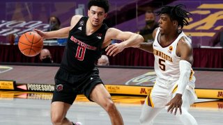 Rutgers' Geo Baker (0) tries to evade Minnesota's Marcus Carr (5) in the second half of an NCAA college basketball game, Saturday, March 6, 2021, in Minneapolis. Rutgers won 77-70.
