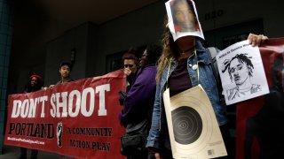 FILE - In this March 22, 2017, file photo, one person wears a bullseye and photo mask of Quanice Hayes, who was shot and killed by a Portland police officer, during a press conference in Portland, Ore. City commissioners apologized Wednesday, March 10, 2021, to the family of a 17-year-old shot and killed by Portland police, before approving a $2.1 million settlement of the family's federal wrongful death lawsuit. The Oregonian/OregonLive reports Quanice Hayes’ grandmother and two uncles said they remain disturbed that Officer Andrew Hearst still works for the Police Bureau and faced no discipline.