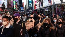 People participate in a protest to mark the one year anniversary of Breonna Taylor's death