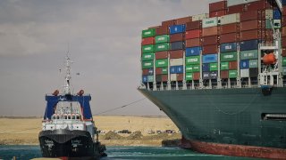 A tugboat takes part in the refloating operation carried out to free the "Ever Given", a container ship operated by the Evergreen Marine Corporation, which is currently stuck in the Suez Canal.