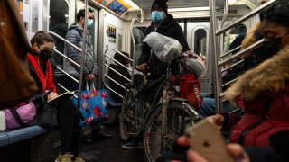 Passengers ride on a downtown subway car on February 23, 2021 in New York City.