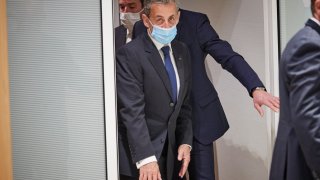In this March 1, 2021, file photo, former French President Nicolas Sarkozy leaves court after being found guilty of corruption and influence-peddling in Paris, France.