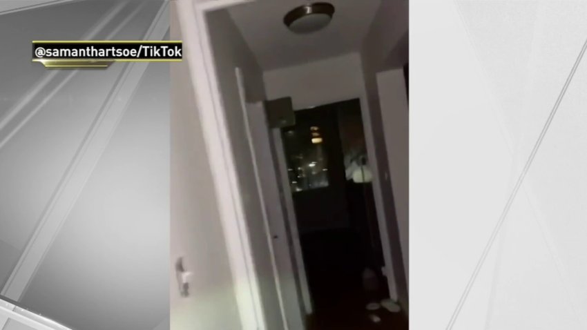 woman exploring empty apartment next to her bathroom