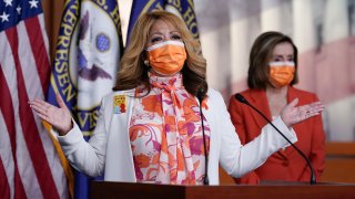 In this March 11, 2021, photo, Rep. Lucy McBath, D-Ga., whose son was a victim of gun violence, joins Speaker of the House Nancy Pelosi, D-Calif., at a news conference on passage of gun violence prevention legislation, at the Capitol in Washington. The House recently passed legislation that would require background checks for gun purchases, a signature Democratic issue for decades. But there wasn’t so much as a statement issued by the White House. President Joe Biden’s views on gun regulation have evolved along with his party.