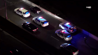 Police vehicles sit on the Major Deegan Expressway where officials say two vehicles exchanged gunfire early Saturday morning