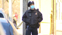 Police officer in New York City stands at the crime scene of a shooting in Brooklyn