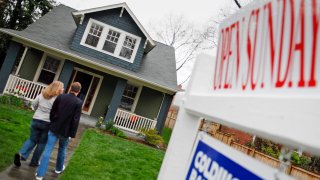 Prospective buyers visit an open house for sale in Alexandria, Virginia.