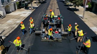 workers with the San Francisco Department of Public Works repave