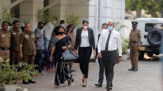Mrs. World 2019 Caroline Jurie, center, leaves a police station after obtaining bail in Colombo, Sri Lanka