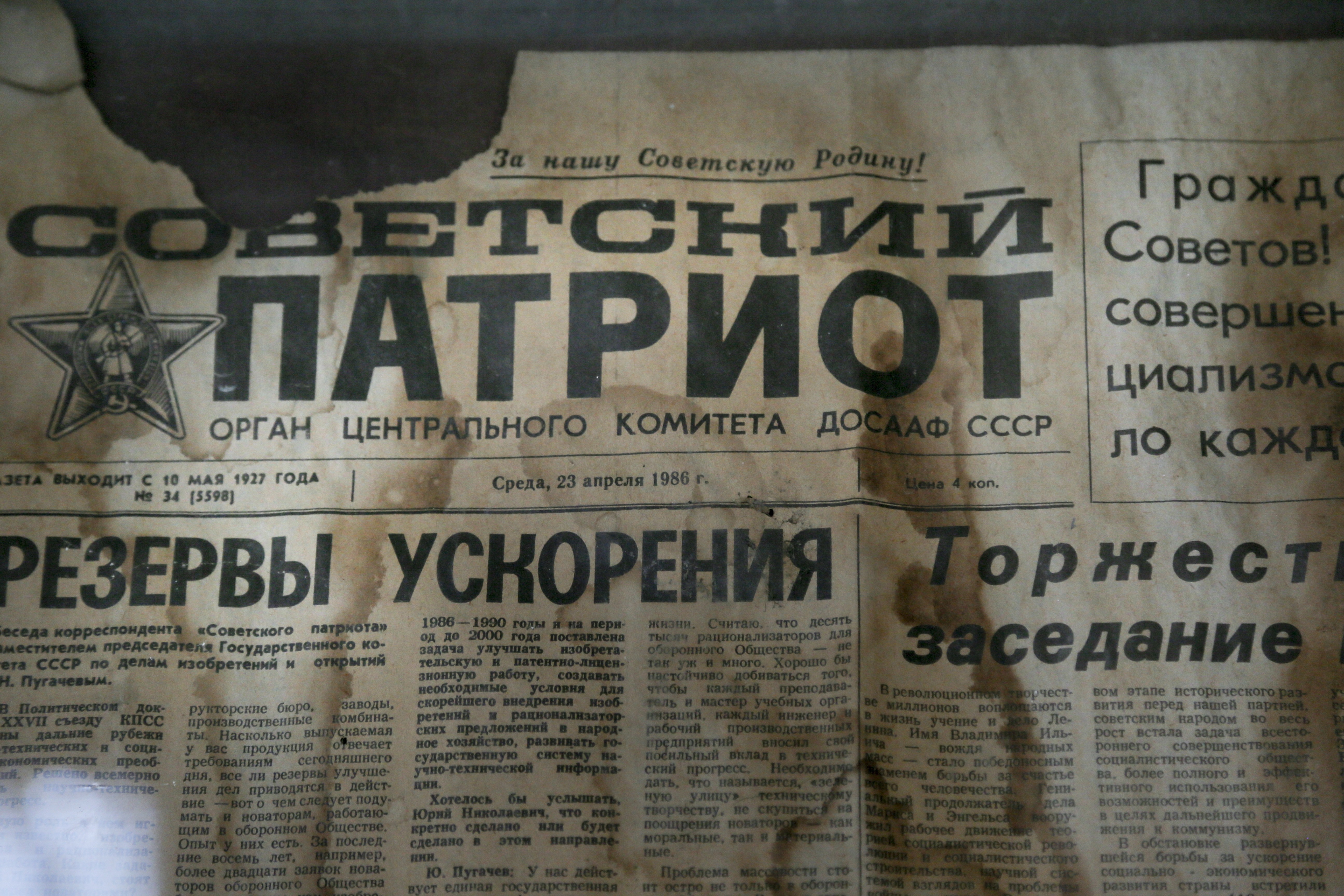 An edition of the newspaper Sovetsky Patriot, dated three days before the nuclear explosion, is attached to a bulletin board in a house of culture in the deserted town of Pripyat, Ukraine, April 5, 2017.