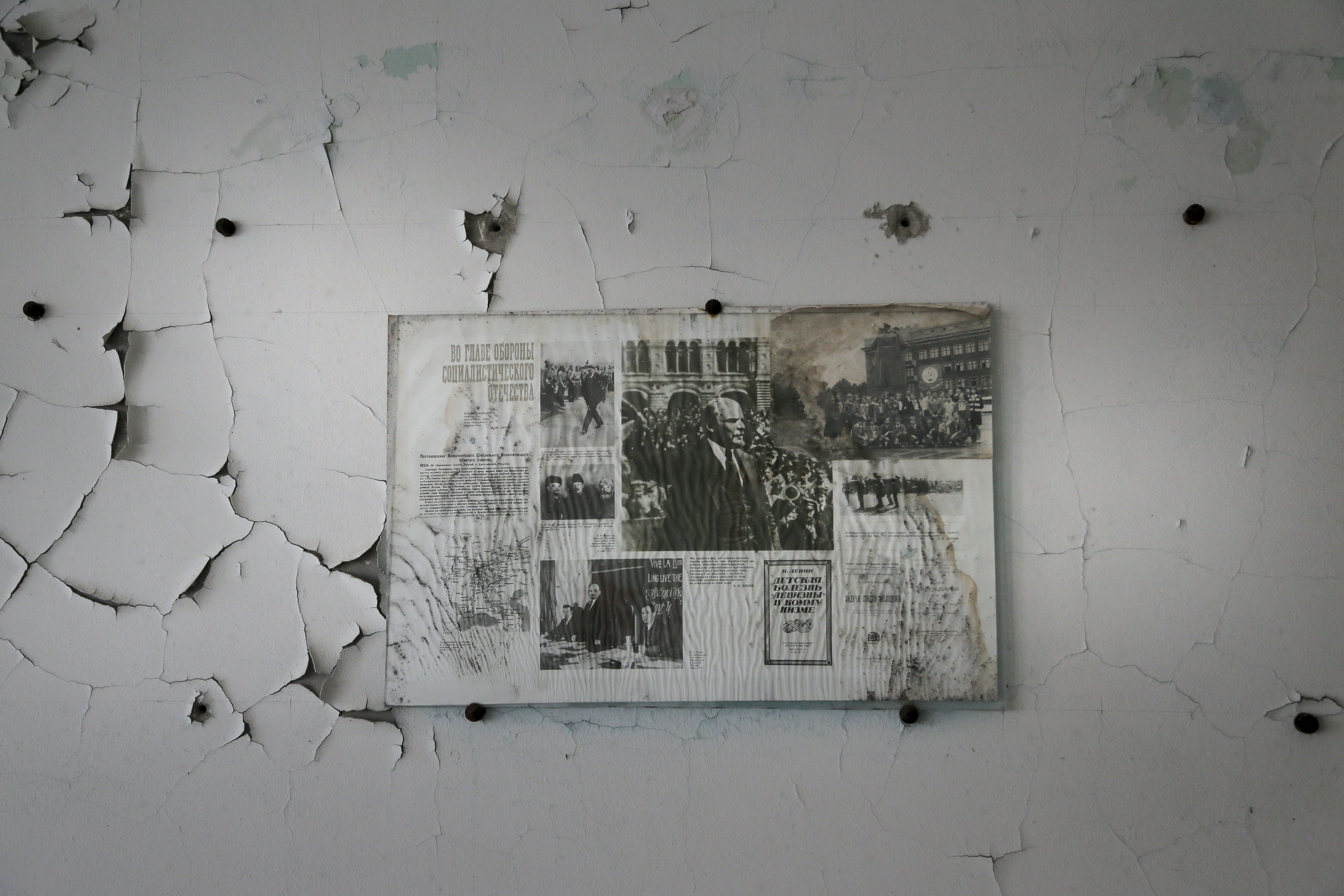 A bulletin board with pictures of Soviet state founder Vladimir Lenin hangs on a wall in a school in the deserted town of Pripyat, Ukraine, April 5, 2017.