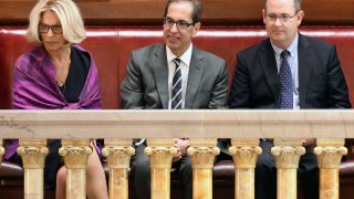 Janet DiFiore, chief judge of the New York Court of Appeals, left, sits with newly confirmed Associate Judge Paul Feinman, center, and his husband Robert Ostergaard, right, in the Senate gallery after being confirmed by the Senate, in Albany, New York, June 21, 2017.