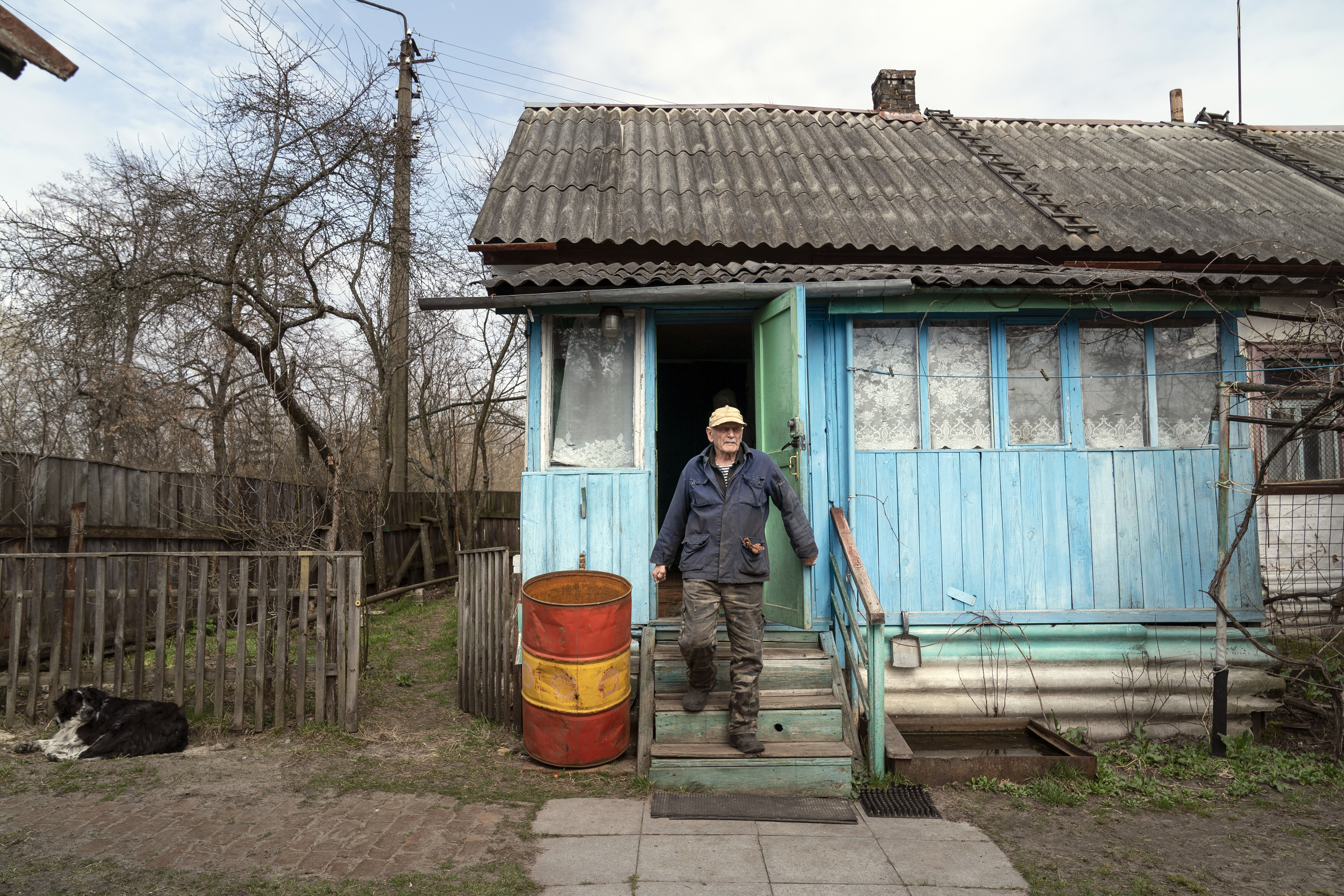 Yevgeny Markevich, a 85-year-old former teacher, leaves his house at the Chernobyl exclusion zone, Ukraine, April 14, 2021. Markevich said “It’s a great happiness to live at home, but it’s sad that it’s not as it used to be.”