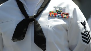 A US Navy sailor awaits the start of his re-enlistment ceremony on July 28, 2011 outside the Staples Center in downtown Los Angeles in conjunction with the Summer X-Games. Earlier this year US President Barack Obama asked the Pentagon to find $400 billion in cuts to national security but as the August 2 debt ceiling deadline approaches some members of Congress have suggested doubling that number to cut $800 billion from defense spending as part of efforts to reduce the nation’s $14.3 trillion debt. AFP PHOTO / Robyn Beck (Photo by Robyn BECK / AFP) (Photo by ROBYN BECK/AFP via Getty Images)
