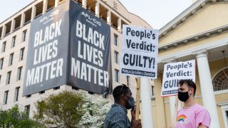 People carry signs after the verdict is announced in the trial of former Minneapolis police officer Derek Chauvin in Black Lives Matter Plaza in Washington, D.C., U.S., on April 20, 2021. Former Minneapolis police officer Derek Chauvin was found guilty of killing George Floyd when he knelt on the mans neck for 9 minutes and 29 seconds, a videotaped death that ignited a summer of rage and the greatest racial reckoning in the U.S. since the 1960s.