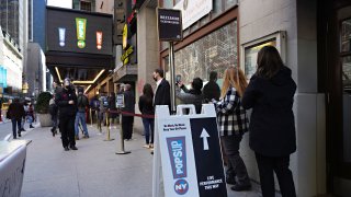 Attendees wait in line as Broadway's St. James Theatre reopens with an exclusive performance for frontline workers as part of NY PopsUp on April 03, 2021 in New York City