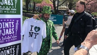 Man in marijuana suit at "Jabs for Joints" event