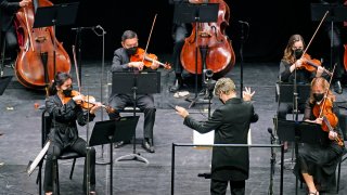 Essa-Pekka Salonen, music director of the San Francisco Symphony and principal conductor of London's Philharmonia Orchestra, leads members of the New York Philharmonic as a guest conductor before an audience of 150 concertgoers at The Shed in Hudson Yards, Wednesday, April 14, 2021, in New York. It was the first time since March 10, 2020, that the entire orchestra performed together in front of a live audience.